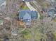 Aerial view of backyard including deck, firepit, and surrounding trees at 8304 Circlewood Ct, Raleigh, NC 27615