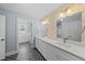 Stylish bathroom with patterned floors, double vanity, and modern lighting, offers a luxurious feel at 8304 Circlewood Ct, Raleigh, NC 27615