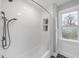 Clean white bathroom with subway tiled walls, a shower with curtain, and a window, maximizing natural light at 8304 Circlewood Ct, Raleigh, NC 27615