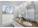 Bright bathroom featuring double sinks, granite countertop, and frosted window, perfect for a modern home at 8304 Circlewood Ct, Raleigh, NC 27615