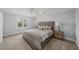 Well-lit bedroom with neutral decor, carpet, and ceiling fan at 8304 Circlewood Ct, Raleigh, NC 27615