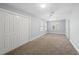 Bright bedroom featuring carpet floors, neutral walls, and large double door closet at 8304 Circlewood Ct, Raleigh, NC 27615