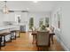 Bright dining room with hardwood floors, large windows, and a view to the outdoor patio at 8304 Circlewood Ct, Raleigh, NC 27615