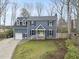 Charming two-story home with blue siding, black shutters, and a bright yellow front door at 8304 Circlewood Ct, Raleigh, NC 27615