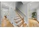 Hallway with hardwood floors and stairs leading to upper level at 8304 Circlewood Ct, Raleigh, NC 27615
