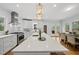 Open-concept kitchen with a large island, stainless steel appliances, and view to the dining area at 8304 Circlewood Ct, Raleigh, NC 27615