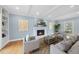 Bright living room with fireplace, art, hardwood flooring, and natural light at 8304 Circlewood Ct, Raleigh, NC 27615