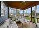 Inviting screened porch with comfortable seating and wood ceiling, perfect for relaxing outdoors at 8304 Circlewood Ct, Raleigh, NC 27615