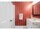 Charming bathroom with red striped wallpaper, marble vanity, decorative mirror, and patterned tile flooring at 100 Dunedin Ct, Cary, NC 27511