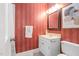 Charming bathroom with red striped wallpaper, marble vanity, decorative mirror, and patterned tile flooring at 100 Dunedin Ct, Cary, NC 27511