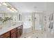 Bright bathroom featuring double sinks, tub and gold framed shower at 100 Dunedin Ct, Cary, NC 27511