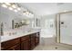 Bright bathroom featuring double sinks, tub and gold framed shower at 100 Dunedin Ct, Cary, NC 27511
