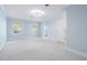 Spacious bedroom featuring plush carpet, two windows, and a modern ceiling fan at 100 Dunedin Ct, Cary, NC 27511