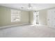 Spacious, carpeted bedroom with a ceiling fan and plenty of natural light at 100 Dunedin Ct, Cary, NC 27511