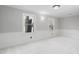 Bright bedroom with pristine carpet and white trim around the double windows at 100 Dunedin Ct, Cary, NC 27511