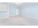 Bright bedroom featuring built-in shelving, neutral carpet, and light blue walls at 100 Dunedin Ct, Cary, NC 27511