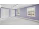 Bedroom with plush carpet, soft purple walls, and bright natural light at 100 Dunedin Ct, Cary, NC 27511