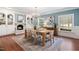 Charming dining room with hardwood floors, blue walls, and built-in shelves surrounding the fireplace at 100 Dunedin Ct, Cary, NC 27511