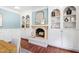 Dining room with fireplace, and custom built-ins, featuring hardwood floors, and blue-painted walls at 100 Dunedin Ct, Cary, NC 27511