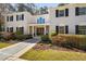 Elegant white brick home with a symmetrical facade and manicured landscaping at 100 Dunedin Ct, Cary, NC 27511