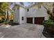 Home exterior featuring a two-car garage and white siding at 100 Dunedin Ct, Cary, NC 27511