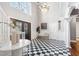 Grand foyer featuring a checkered floor, high ceilings, and a beautiful chandelier at 100 Dunedin Ct, Cary, NC 27511
