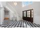 Spacious foyer with black and white checkered flooring and a grand staircase at 100 Dunedin Ct, Cary, NC 27511