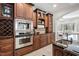 Spacious kitchen with wood cabinets, granite counters, stainless appliances, and open layout to the dining area at 100 Dunedin Ct, Cary, NC 27511