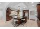 Elegant kitchen featuring a dark wood cabinets, granite countertops, and a large center island with seating at 100 Dunedin Ct, Cary, NC 27511