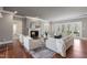 Sophisticated living room featuring a fireplace, hardwood floors, and french doors leading to another living space at 100 Dunedin Ct, Cary, NC 27511