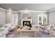 Serene living room with a fireplace, hardwood floors, and comfortable seating arrangement at 100 Dunedin Ct, Cary, NC 27511