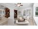 Inviting living room with a built-in cabinet, neutral armchairs, and seamless transition to the kitchen at 100 Dunedin Ct, Cary, NC 27511