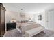 Bright main bedroom showcasing a king bed, bench, and stylish nightstands for a relaxing retreat at 100 Dunedin Ct, Cary, NC 27511