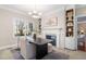 Office with large window, fireplace, and built-in bookshelves at 100 Dunedin Ct, Cary, NC 27511