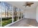Relaxing screened porch with wooden floors and ceiling fan at 100 Dunedin Ct, Cary, NC 27511