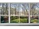 Large picture window showcasing the lush greenery of the backyard at 100 Dunedin Ct, Cary, NC 27511