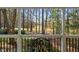 Exterior view from a porch overlooking a tranquil green space with mature trees at 100 Dunedin Ct, Cary, NC 27511