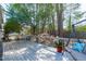 Wood deck with outdoor furniture, shaded by mature trees and overlooking the backyard at 1004 Plateau Ln, Raleigh, NC 27615