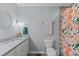 Bathroom featuring a granite-topped vanity, decorative shower curtain, and updated fixtures at 1004 Plateau Ln, Raleigh, NC 27615