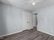 Bedroom with ceiling fan, wood-look flooring, double closet doors, and access to another room at 1004 Plateau Ln, Raleigh, NC 27615