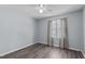 Neutral bedroom featuring a ceiling fan, wood-look flooring, and a bright window at 1004 Plateau Ln, Raleigh, NC 27615