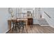 Dining area with stairs to upper level and view into updated kitchen at 1004 Plateau Ln, Raleigh, NC 27615