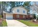 Well-maintained brick home with attached garage and long driveway at 1004 Plateau Ln, Raleigh, NC 27615