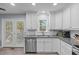 Bright kitchen features stainless steel appliances, granite countertops, and white cabinets at 1004 Plateau Ln, Raleigh, NC 27615