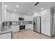 Modern kitchen with stainless steel appliances, white cabinetry, and granite countertops at 1004 Plateau Ln, Raleigh, NC 27615