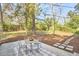 Outdoor dining area in the backyard surrounded by trees provides a secluded relaxation space at 101 Newell St, Durham, NC 27705