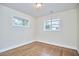 Well-lit bedroom with hardwood floors and two windows providing natural light at 101 Newell St, Durham, NC 27705
