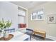 Dining nook with built-in seating and white brick wall, complemented by a dining table and decorative accessories at 101 Newell St, Durham, NC 27705
