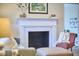 Close-up view of the elegant fireplace in the living room, complemented by cozy seating at 101 Newell St, Durham, NC 27705