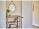 Hallway featuring a wooden console table with plants and decorative items, accented by a round mirror on the wall at 101 Newell St, Durham, NC 27705